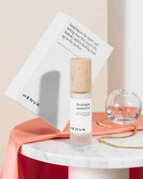 Henua Recharging moisturizer with a white secondary package on a marble table
