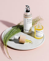 Henua skincare products on a plate with a light pink background