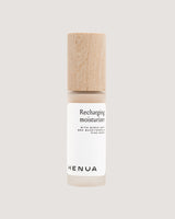 Henua Recharging Moisturizer bottle with wooden cap on a light gray background