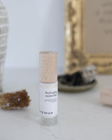 Henua Recharging Moisturizer on a serene background with crystals and sage